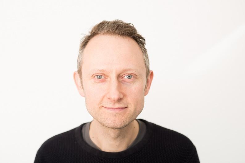 A person in a black shirt Description automatically generated with medium confidence