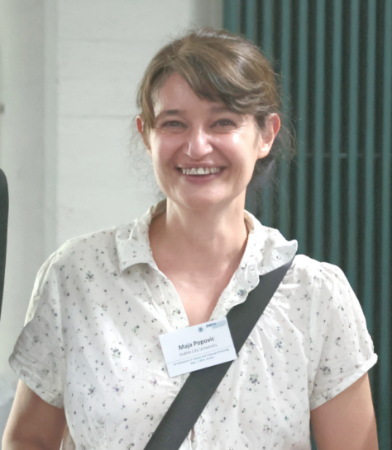 A person smiling at camera Description automatically generated