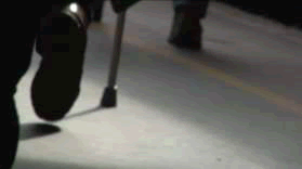 Transition shot: people walking down platform